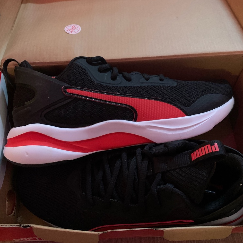 Brand new red and black Puma tennis shoes. Size 5.5. Box damaged from move.